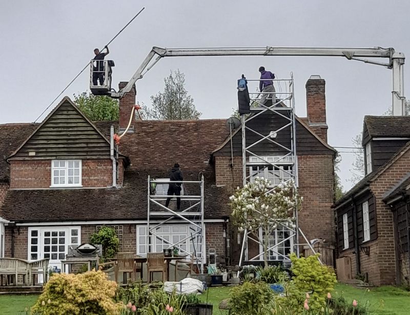 The Roof Moss Cleaners using cherry picker and scaffolding to clean roof safely and professionally in Walton-on-Thames, Surrey