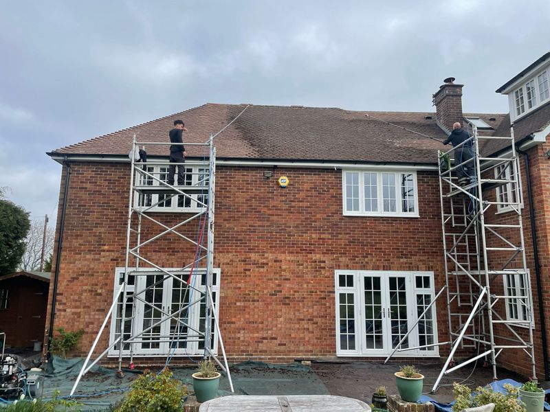 Roof cleaning carried out safely from scaffold towers by The Roof Moss Cleaners in Walton-on-Thames